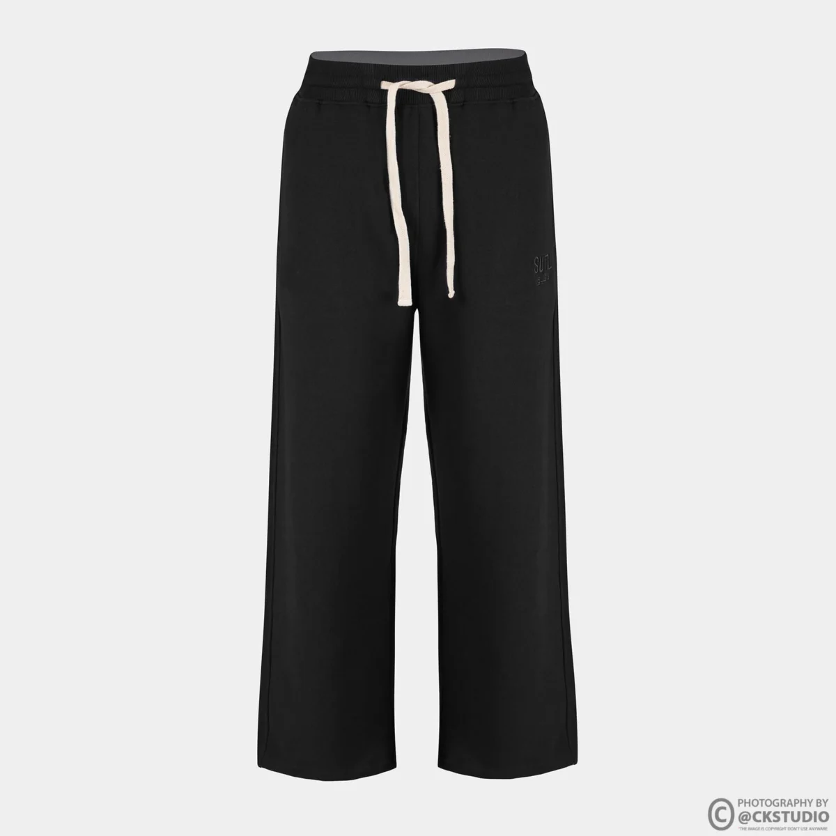 Black drawstring sweatpants photographed as a ghost mannequin front view on a light grey background for a bottomwear catalogue