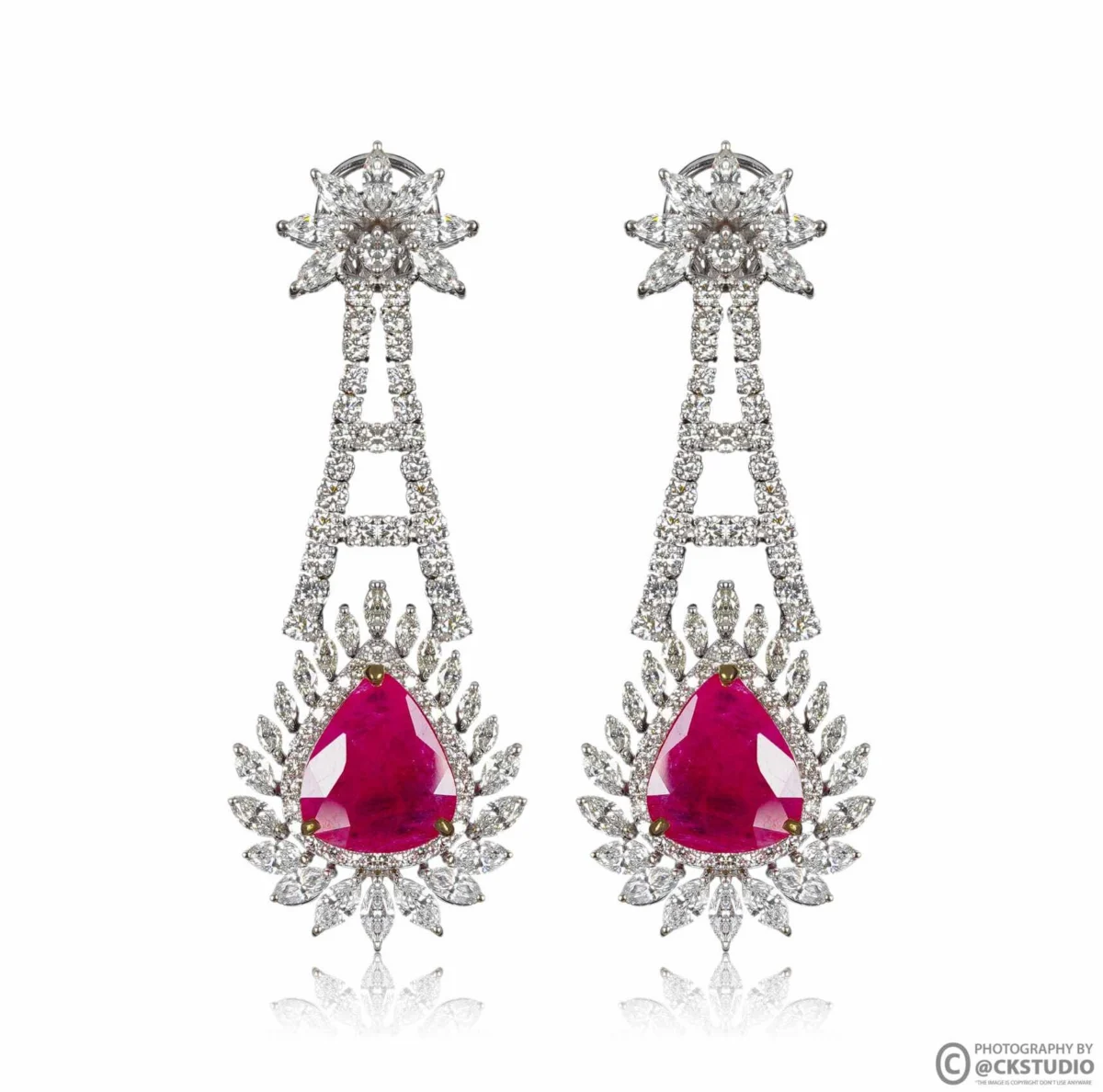 Pair of ruby and diamond drop earrings hanging side by side with matched height and spacing on a pure white background for an earring listing