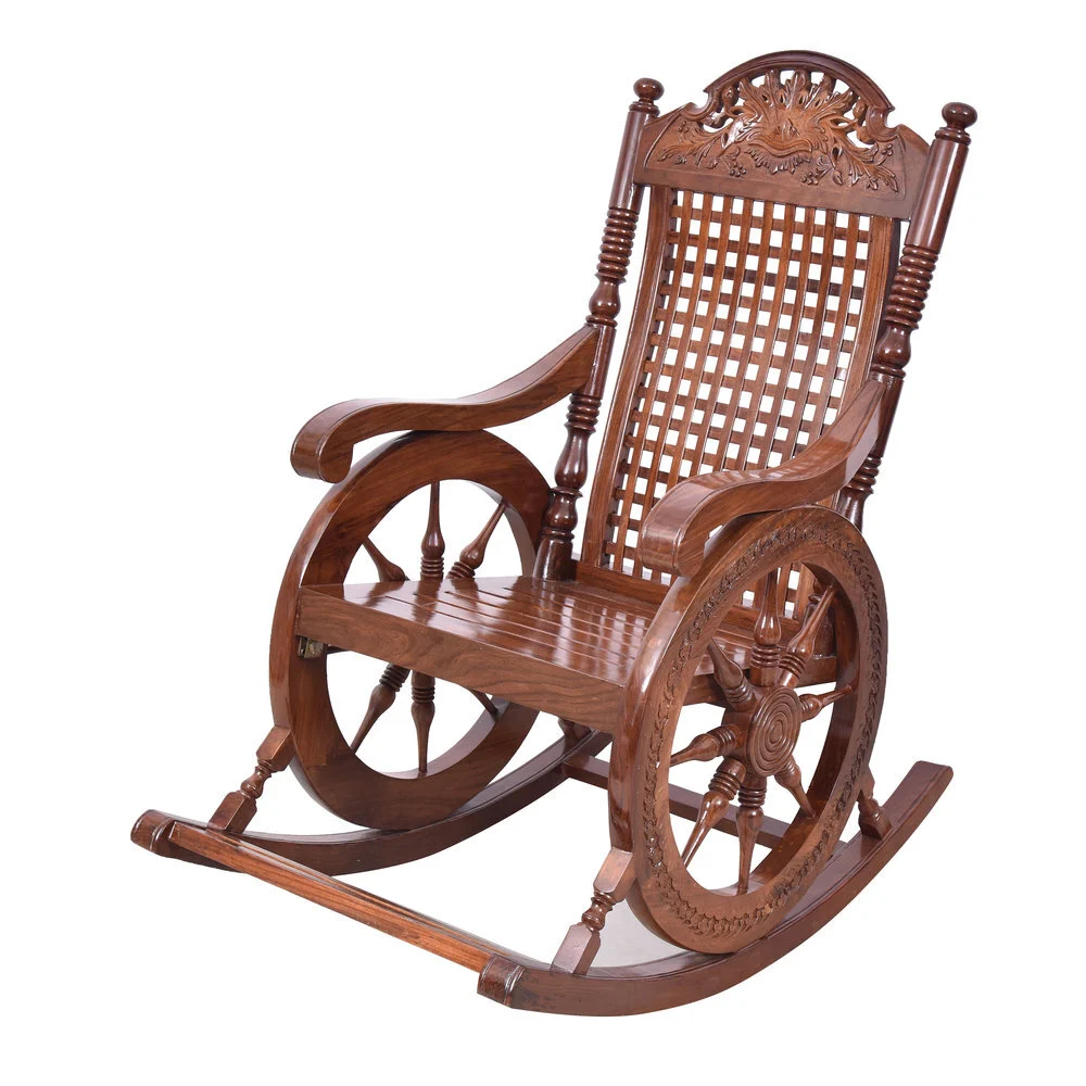 Carved wooden rocking chair with a cane-weave backrest, spoked wheel armrests and curved rockers photographed on white to show carving depth and polished wood grain