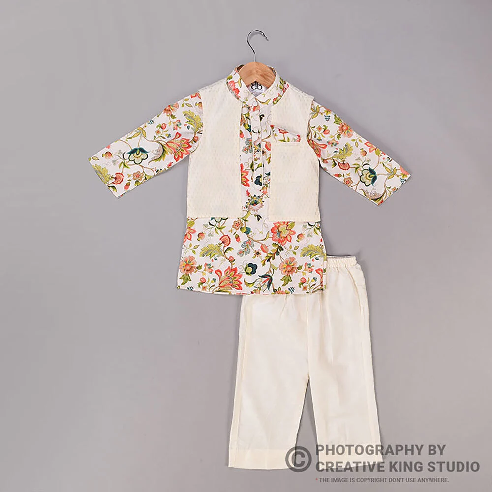 Kids floral kurta with cream nehru jacket and white pyjama laid out on a grey backdrop, a flat lay garment catalogue frame showing print and set pieces