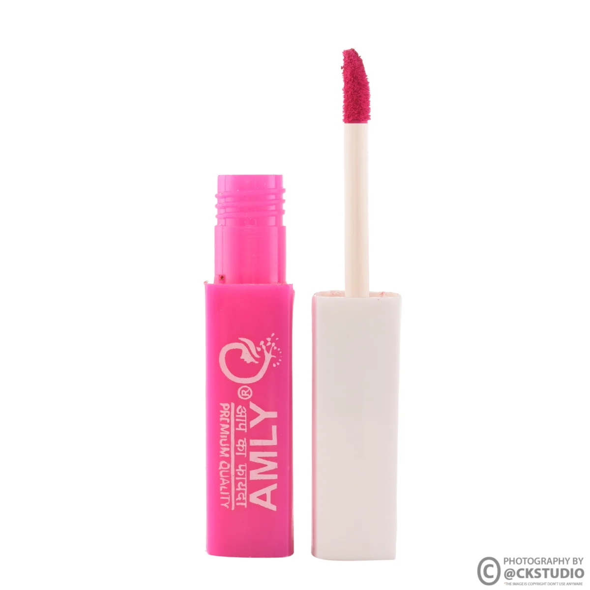 Pink liquid lip tint tube standing upright beside its open applicator on a seamless white background, a clean hero frame for beauty marketplace listings