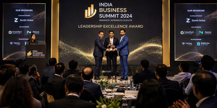 Corporate event photography of an award ceremony stage moment with trophy presentation and engaged audience at an Indian business summit shot by Ckstudio