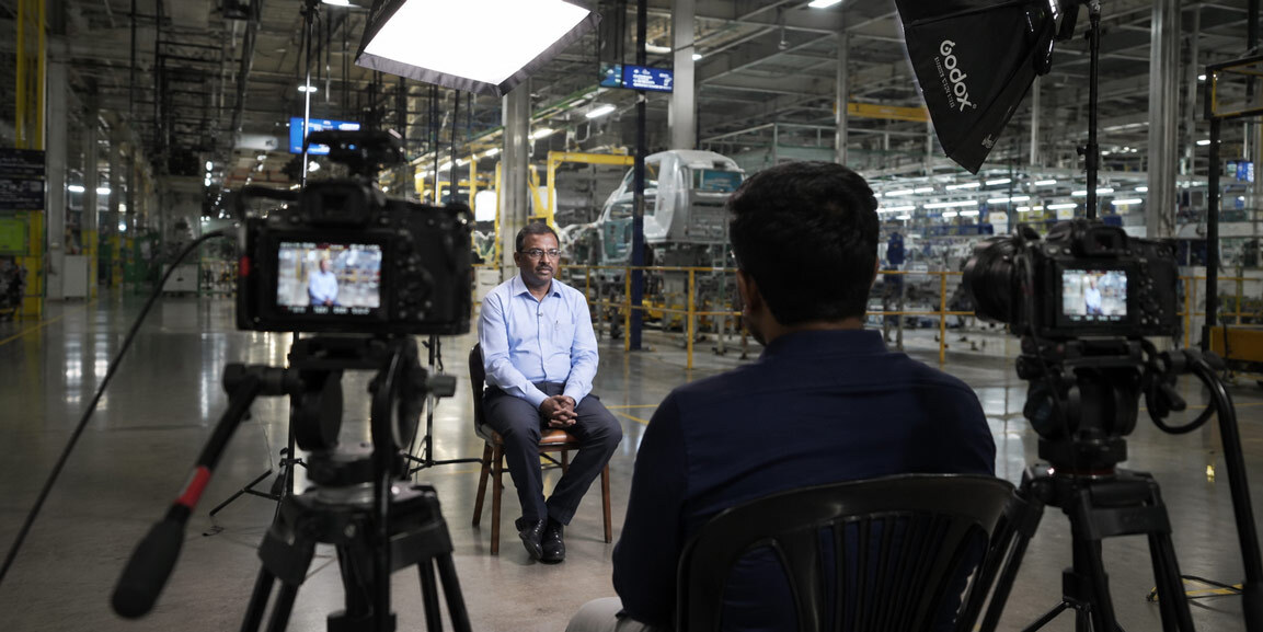 Two camera corporate interview and lighting setup for an industrial videography and manufacturing process film inside an Indian factory facility