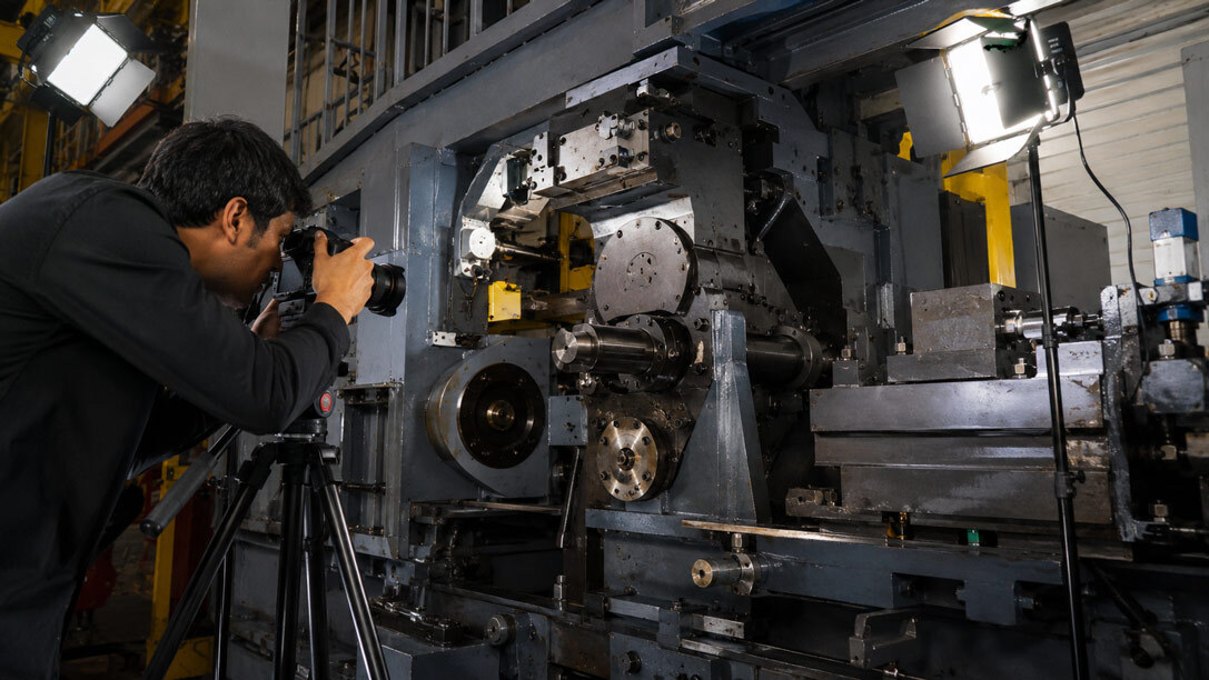 Close-up of heavy industrial machinery with precision metal components lit for professional B2B catalogue photography