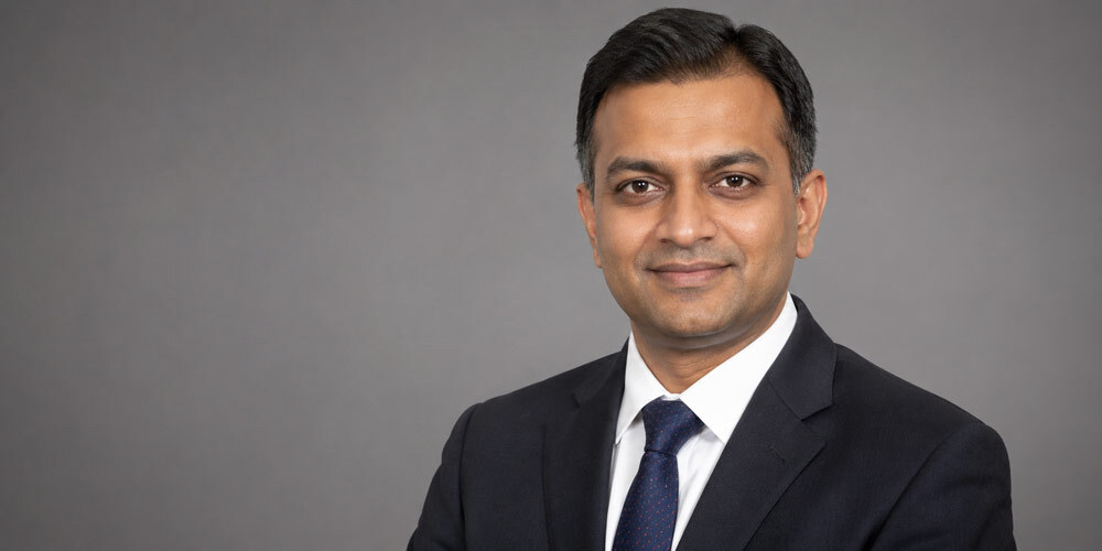 Professional corporate photography session — executive headshot of Indian business leader with controlled studio lighting and clean grey background for LinkedIn and website use