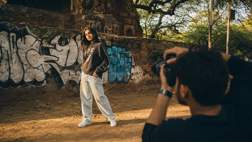 Street fashion photography in Hauz Khas Delhi, young Indian model wearing oversized streetwear, golden hour cinematic light, candid urban pose, 35mm film aesthetic Delhi NCR street style trend 2026 by Ckstudio