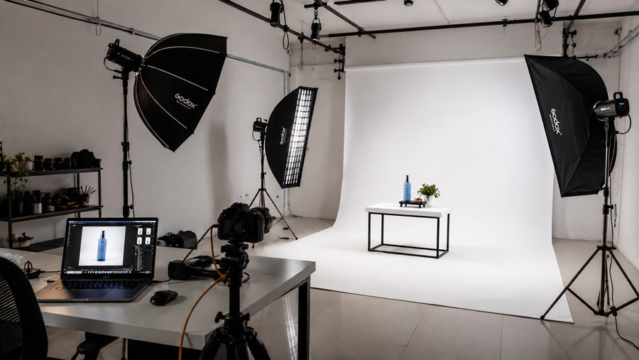 Ckstudio product photography studio interior in Delhi with white cyclorama wall professional strobes softboxes and a tethered tabletop shooting station