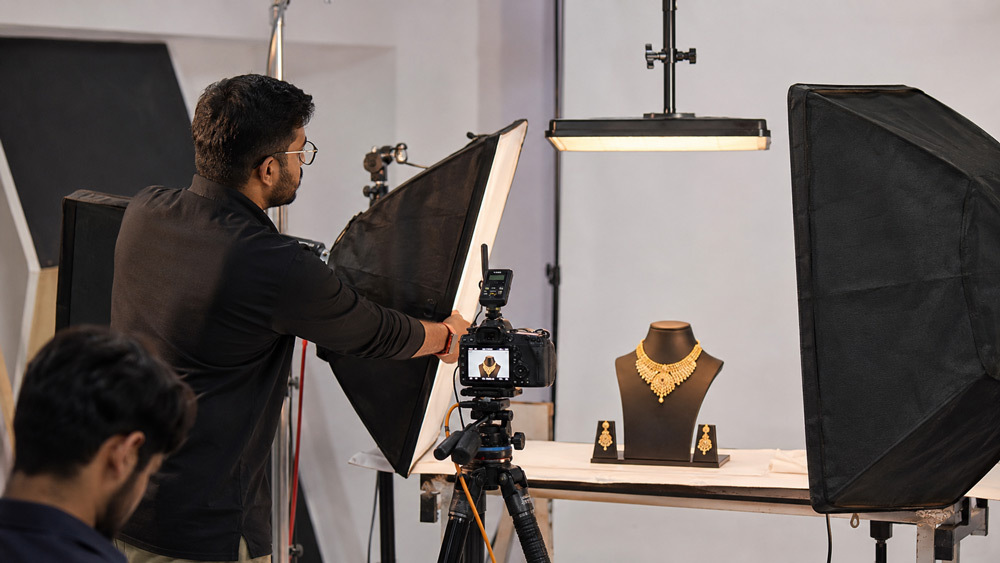 Behind the scenes at Ckstudio Delhi NCR photographer setting up softbox lighting for gold jewellery photography shoot