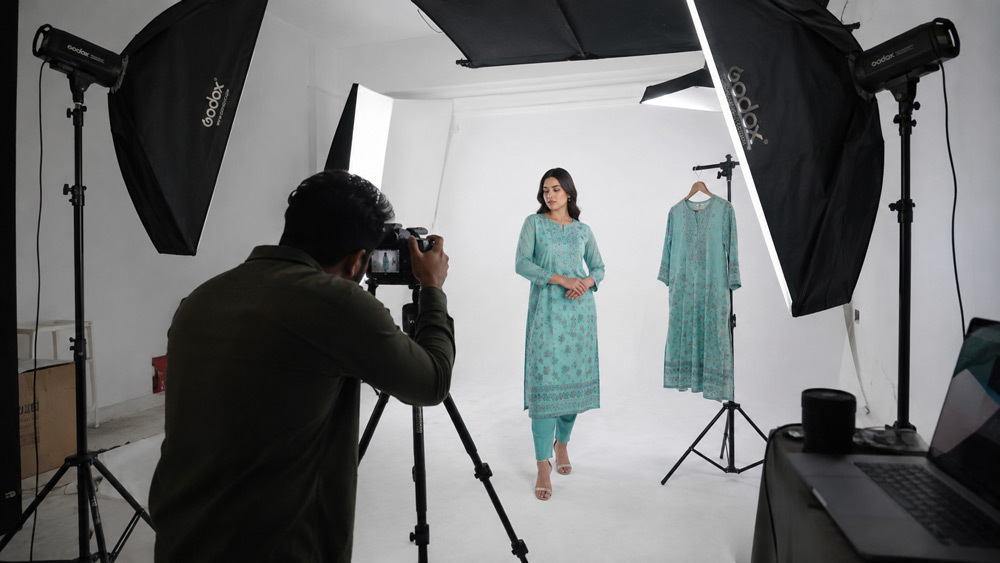 Behind the scenes photograph of Ckstudio fashion apparel ecommerce photoshoot with model wearing kurta on ghost mannequin arrangement under softbox lighting on white cyclorama at Delhi NCR studio