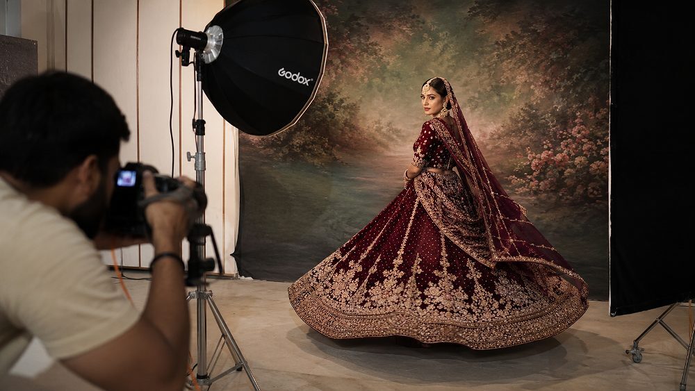 Behind the scenes of bridal model in heavy zari embroidered maroon lehenga at Indian standard ecommerce photography