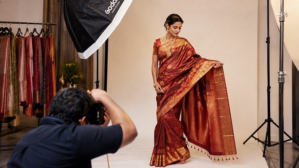 Behind the scenes of live model draped in Kanjeevaram silk saree at Indian standard ecommerce photography studio showing