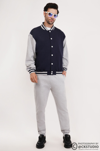 B male model wearing varsity jacket and sweatpants, shot on white background, Commercial Product Photography — Ckstudio