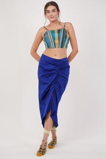 B model wearing blue ruched skirt and striped crop top, standing on white background, Commercial Product Photography shot — Ckstudio