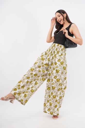 Shot of model wearing floral wide-leg pants and black top on white background — Ckstudio Commercial Product Photography