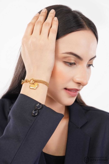 Bangle bracelet on woman in dark blazer, close-up shot — Ckstudio Commercial Product Photography