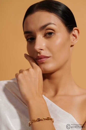 Bangle bracelet on model with beige background, Commercial Product Photography shot — Ckstudio