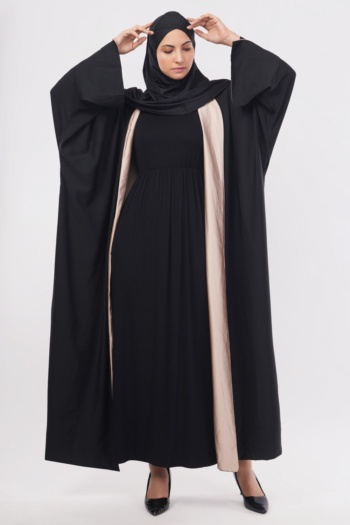 B) Woman wearing black abaya with beige lining, posed on white background, Commercial Product Photography shot — Ckstudio