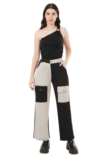 Shot of model wearing black and beige cargo pants and black one-shoulder top on white background — Ckstudio Commercial Product Photography