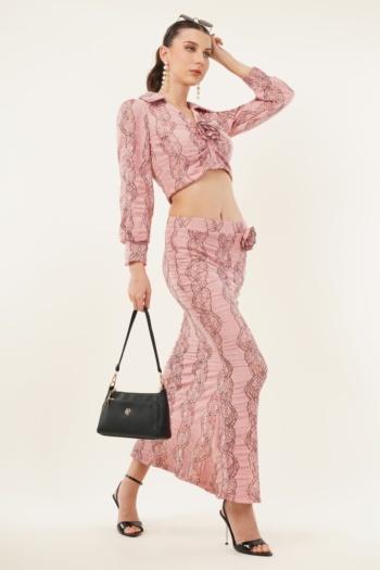 Ckstudio shot of model wearing pink lace two-piece outfit with black handbag on plain white background, Commercial Product Photography