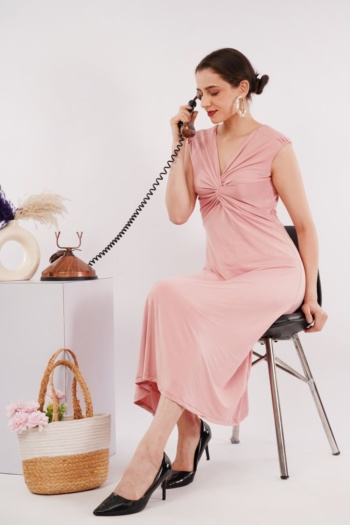 Ckstudio shot of woman in pink dress sitting on chair with vintage phone on white background, Commercial Product Photography