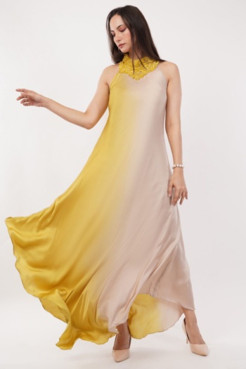 Ckstudio shot of model wearing flowing yellow and beige dress on white background, Fashion Photography