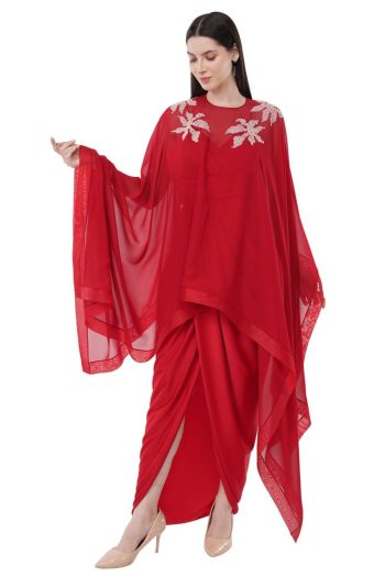 Ckstudio shot of model wearing red draped garment with sheer embellished cape on white background, Garment Photography
