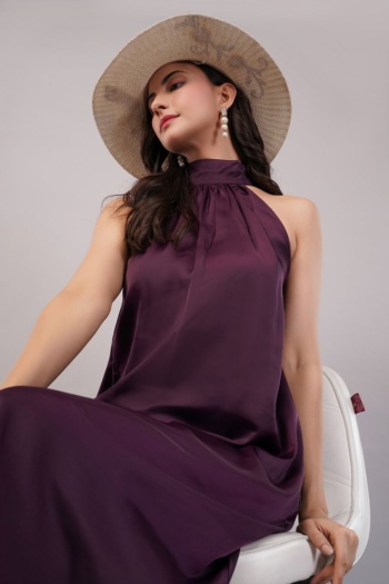 Ckstudio shot of model wearing purple halter dress and straw hat on light gray background, E-Commerce Photography
