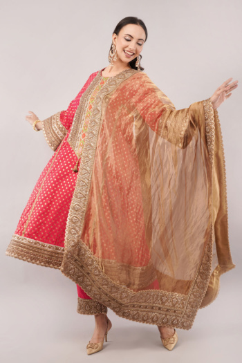 B) model wearing traditional embellished outfit, beige backdrop, shot — Ckstudio, Commercial Product Photography