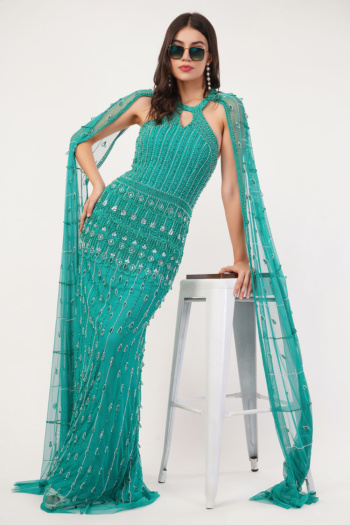Ckstudio shot of model wearing embellished teal gown on white stool against plain white background, Garment Photography