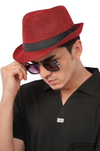 Ckstudio shot of a model wearing a red hat and sunglasses on a neutral background — Commercial Product Photography.