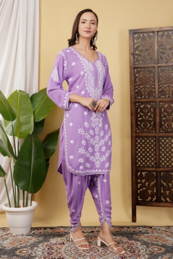 B woman wearing purple embroidered kurta and pants, standing indoors with plant and wooden screen, Commercial Product Photography shot — Ckstudio