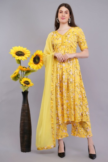 B) model wearing yellow floral ethnic wear, standing beside tall vase with sunflowers, shot — Ckstudio; Commercial Product Photography