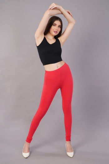 shot of model wearing black crop top and red leggings on gray background — Ckstudio; Commercial Product Photography