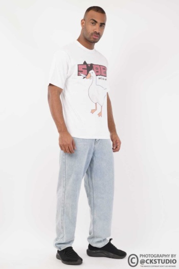 Shot of male model wearing graphic t-shirt and light denim jeans on white background — Ckstudio Fashion Photography