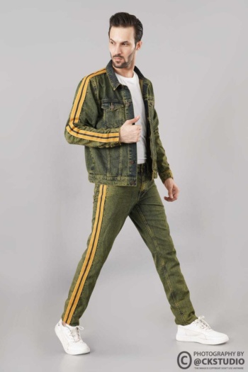 Shot of male model wearing green denim jacket and pants with yellow stripes on gray background — Ckstudio Fashion Photography