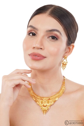 Ckstudio shot of woman wearing gold necklace and earrings on white background — Jewellery Photography