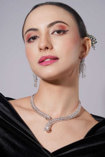 Shot of woman wearing diamond necklace and earrings on light gray background — Ckstudio Commercial Product Photography