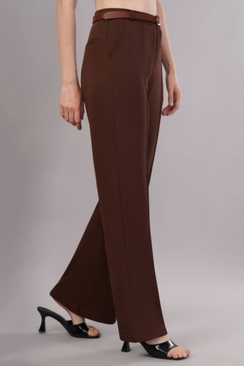 Ckstudio shot of brown trousers with belt and black heels on grey background — Garment Photography