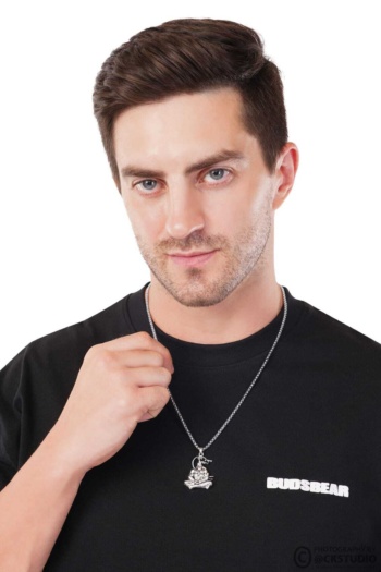 Buddha pendant necklace on male model, black shirt, white background, Commercial Product Photography shot — Ckstudio