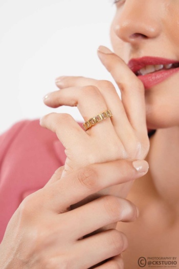 A shot of gold ring on hand with red lips and pink sleeve background — Ckstudio Jewellery Photography
