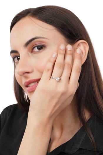 Shot of woman wearing diamond ring on white background — Ckstudio Jewellery Photography