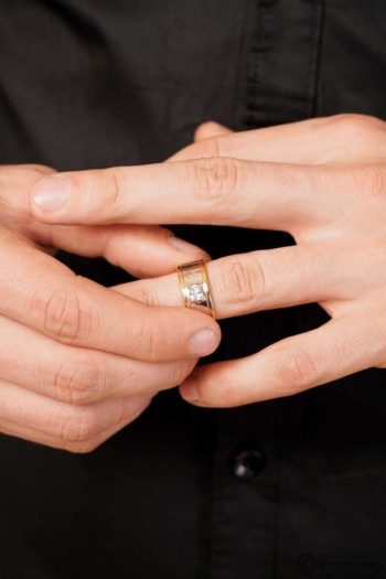 Shot of gold and diamond ring on hand with black shirt background — Ckstudio Jewellery Photography