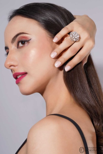 Shot of a woman wearing a diamond ring on a light gray background — Ckstudio Jewellery Photography