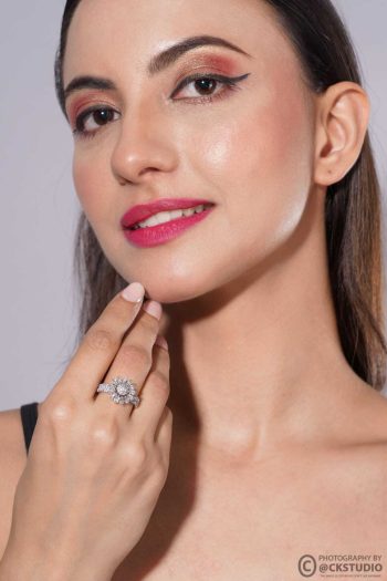 Shot of woman wearing diamond ring on light gray background — Ckstudio Jewellery Photography