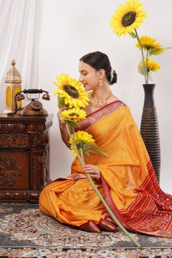 B) woman in orange saree holding sunflowers, sitting on patterned rug with vintage phone and vase, Commercial Product Photography shot — Ckstudio