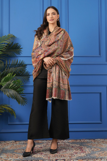 Shot of model wearing patterned shawl on blue paneled wall background — Ckstudio Commercial Product Photography