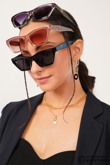 Ckstudio shot of a model wearing stylish sunglasses on a clean white background — Commercial Product Photography.