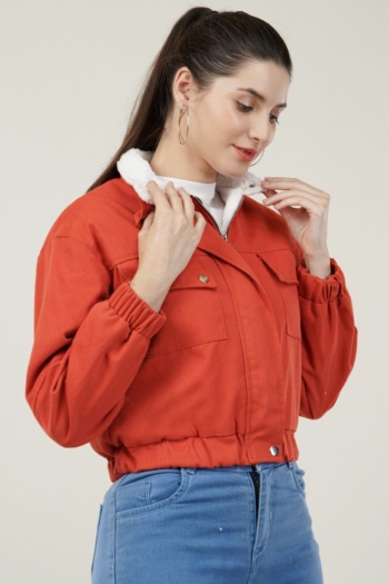 B) Woman wearing orange jacket on plain light background, Commercial Product Photography shot — Ckstudio