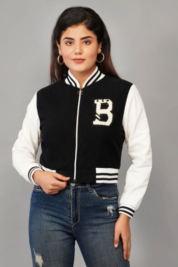 B) model wearing black and white varsity jacket and blue jeans, shot on gray background — Ckstudio; E-Commerce Photography