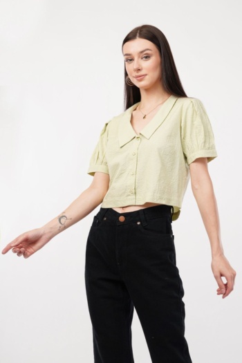 shot of model wearing light green blouse and black pants on white background — Ckstudio Commercial Product Photography